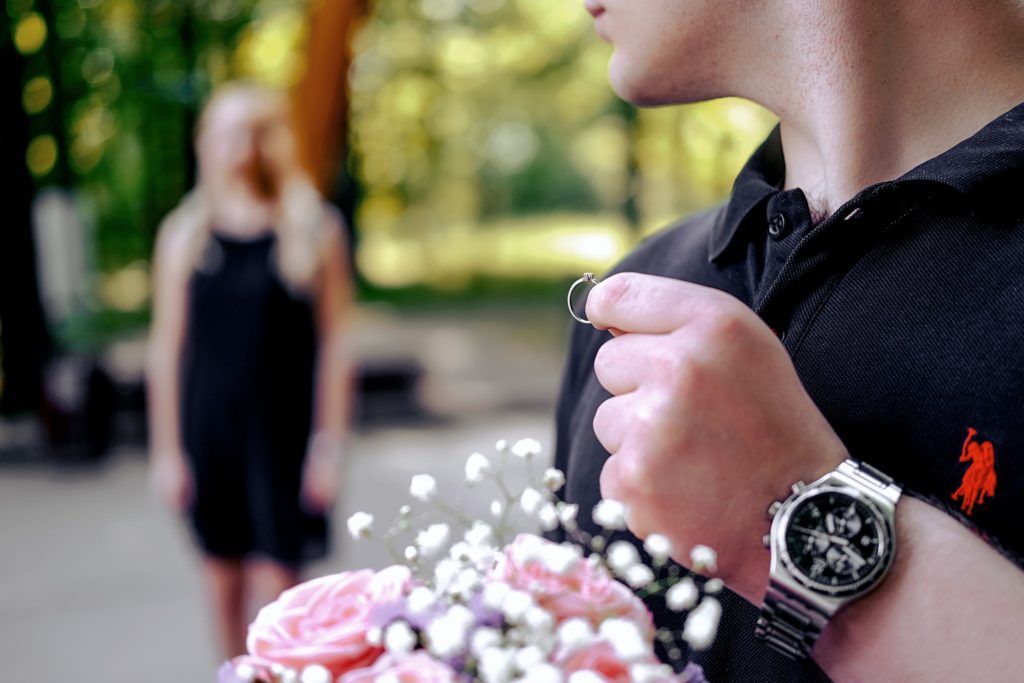 Lady blurred photo stares at boy holding ring