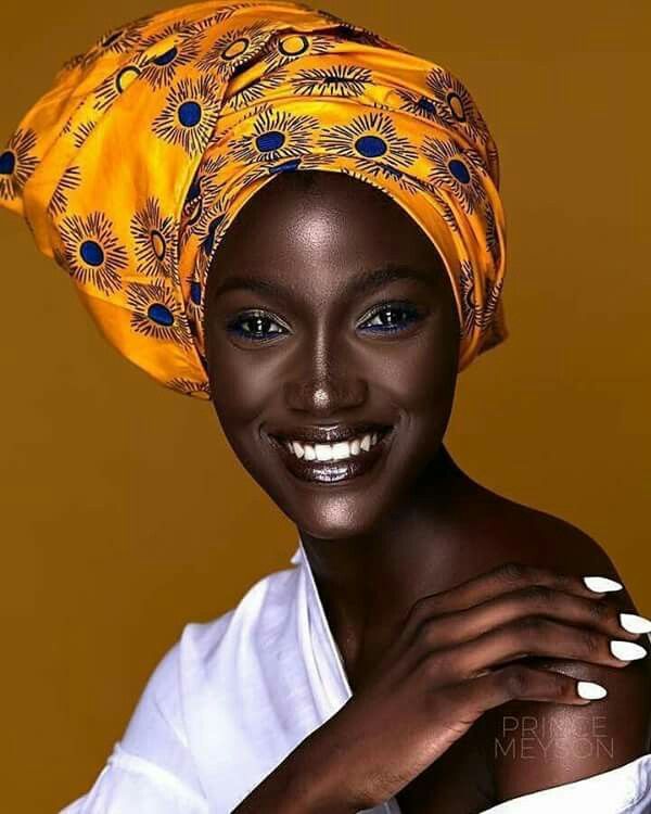 ebony lady rocks African head gear and white top