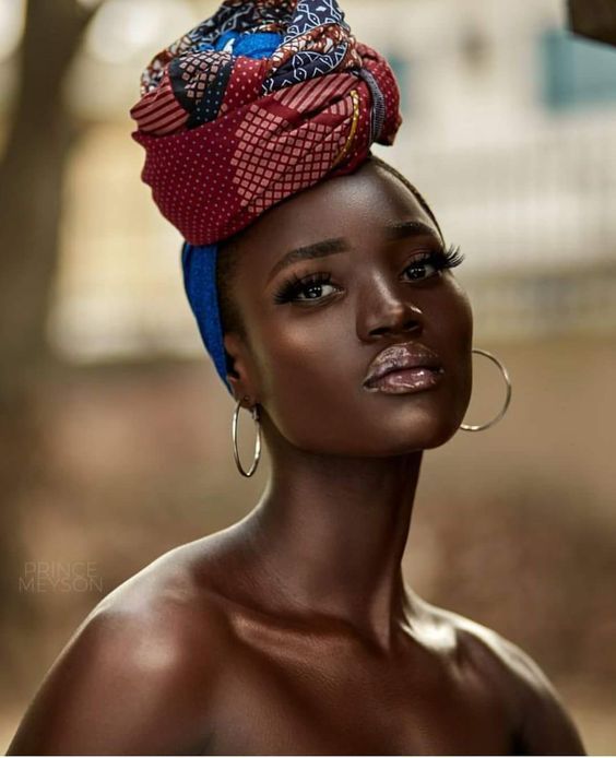 dark skinned lady rocks African head gear